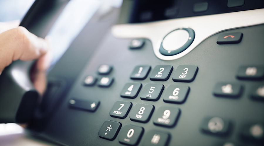 person making call on office VOIP phone