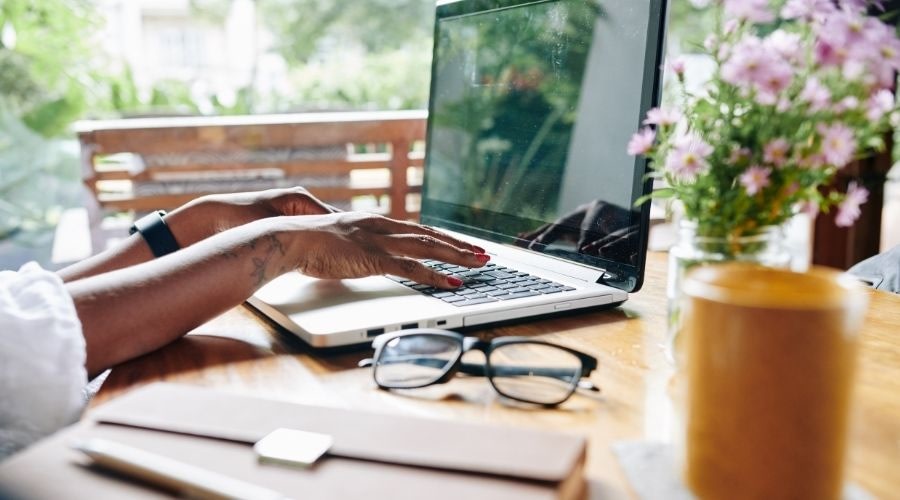 Woman typing on her laptop in a remote work setting.